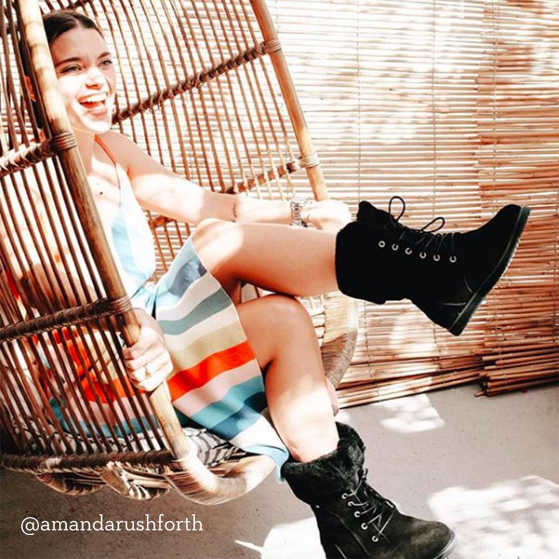 A cheerful mom in a striped dress enjoys the sun in sturdy, waterproof EMU NZ Shoreline Sheepskin Boots with cozy fleece lining.  ksnz