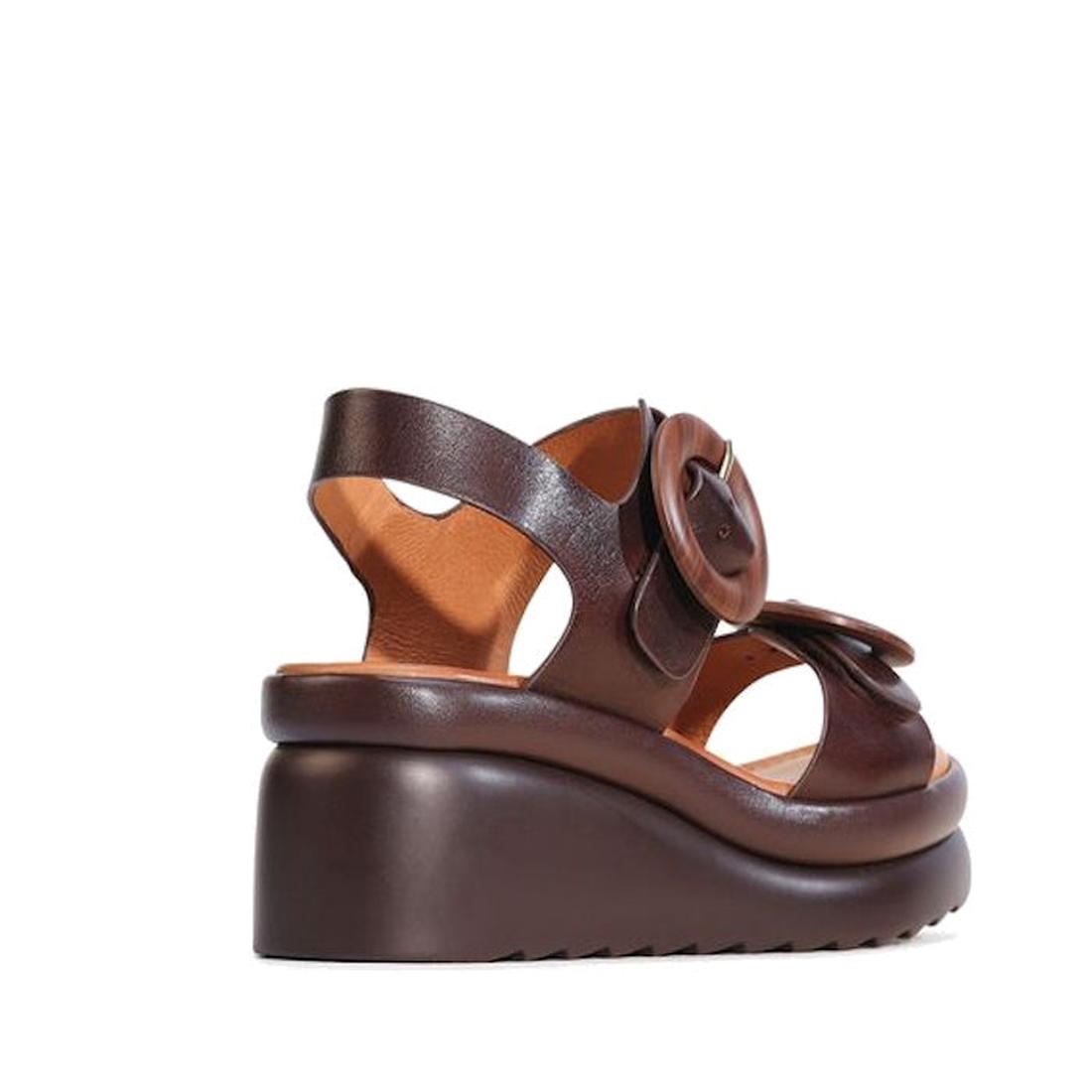 The EOS Menorcas Chestnut Brown Leather Wedge Sandal features a thick sole, large buckle strap, open toe, and anatomical footbed for enhanced arch support, shown against a white background., 49568, 49569, 9321191310664, 9321191310671, 9321191310688, 49573
