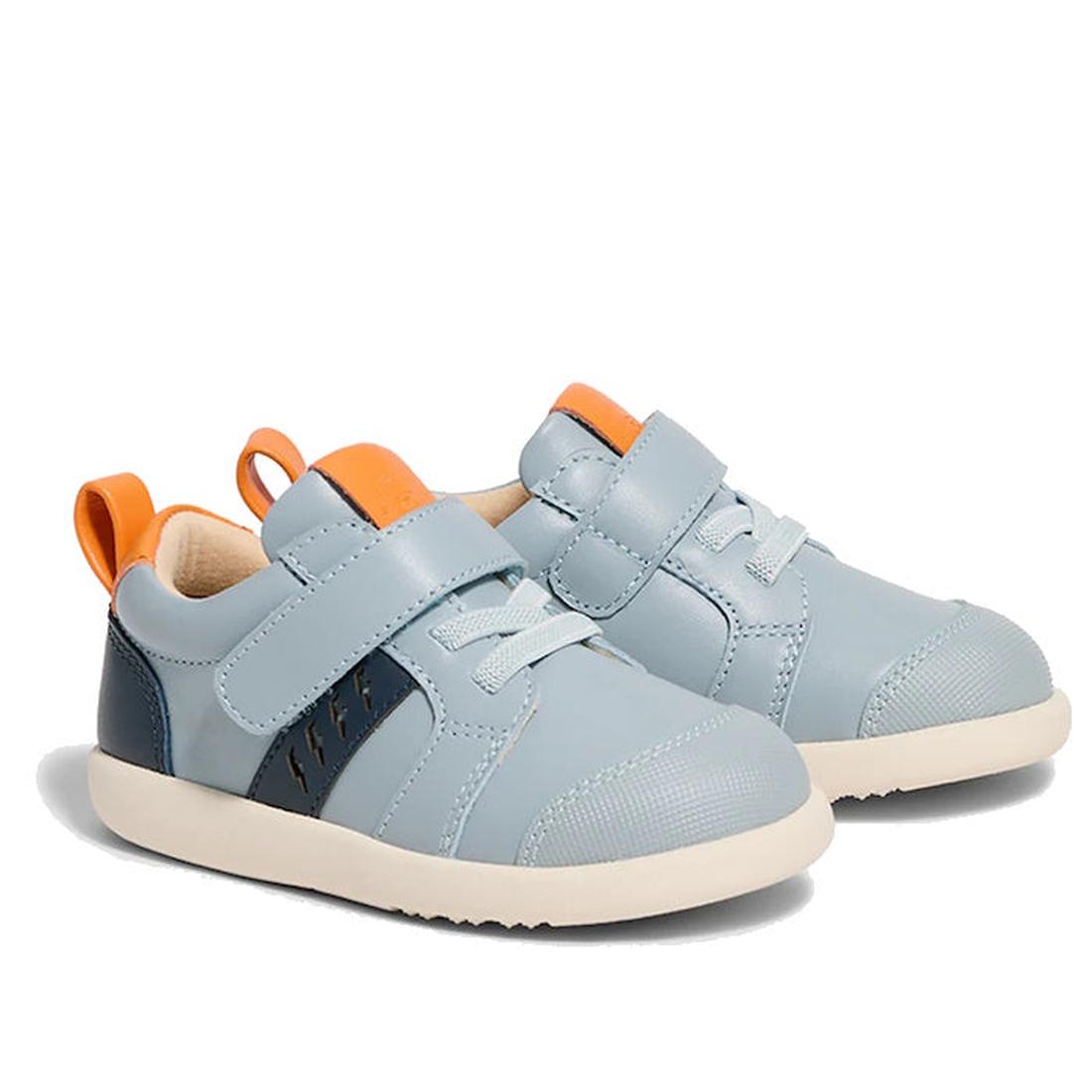 The Pretty Brave SID Leather Trainer First Walker Indigo Blue Grey features light blue leather, white soles, orange pull tabs, dark blue side panels, and hook-and-loop straps—podiatrist approved shoes ideal for early walkers., 9420075362918, 9420075362901