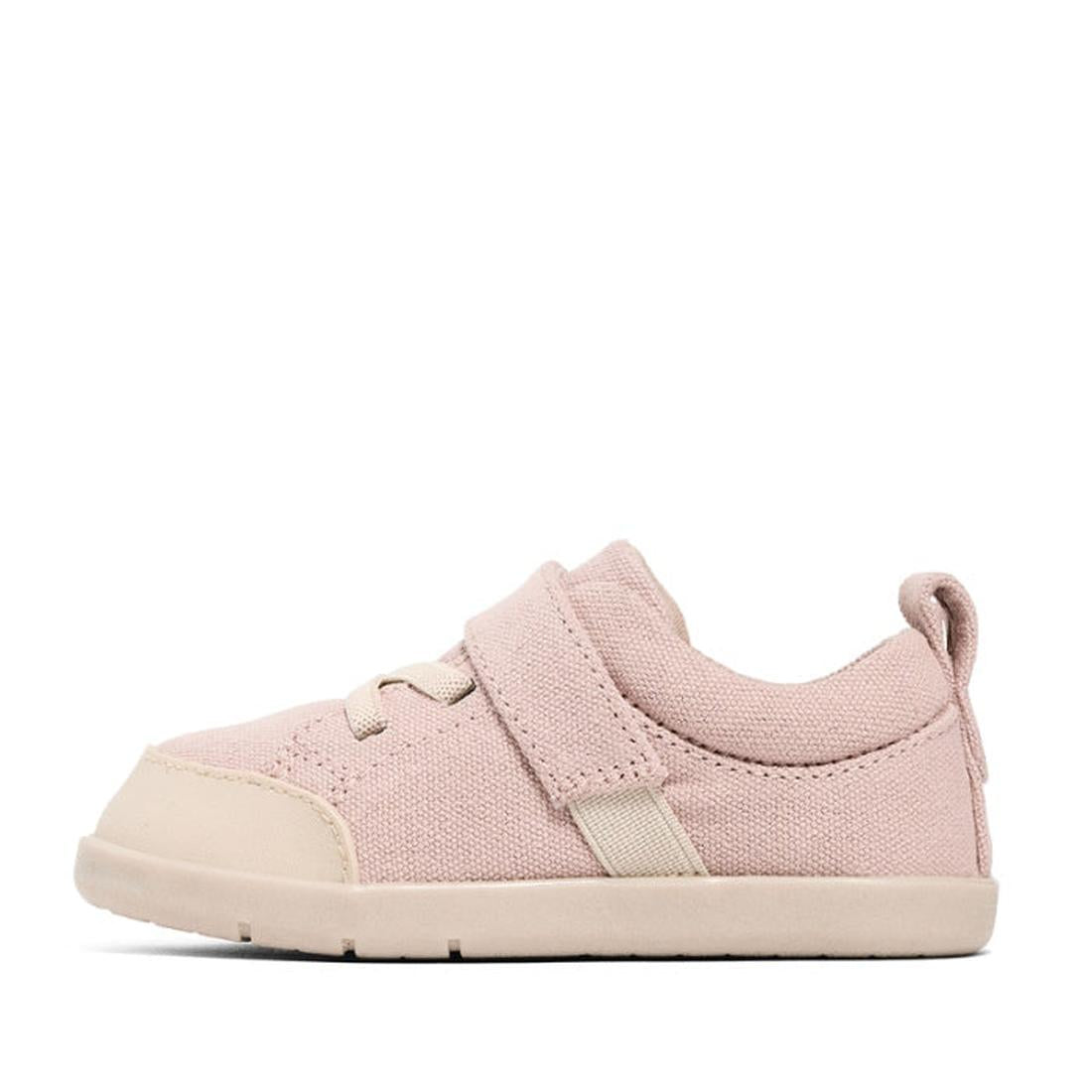 The Pretty Brave Boston CANVAS Trainer First Walker in Blush Pink is a toddler shoe in light pink organic cotton canvas, shown in side profile with a rubber sole, Velcro strap, faux laces, and fabric heel pull tab on a white background., 9420075329829, 94