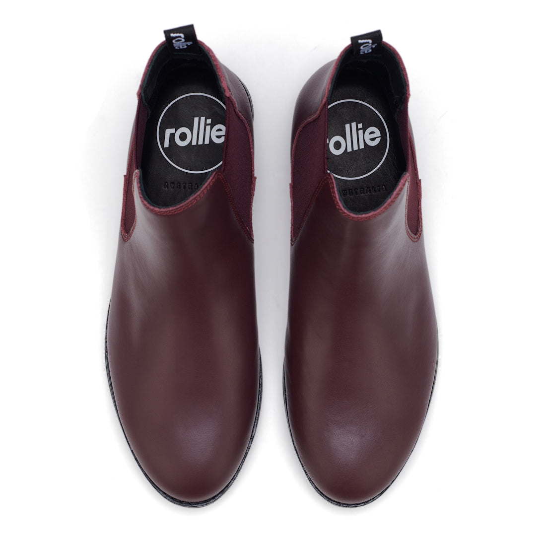 Top view of a pair of Rollie Womens Chelsea Dark Cherry Leather Ankle Boots with black soles, black insoles featuring Rollie branding, and pull tabs at the back., 9339554019543, 9339554104898, 9339554094687, 9339554000190, 9339554073989