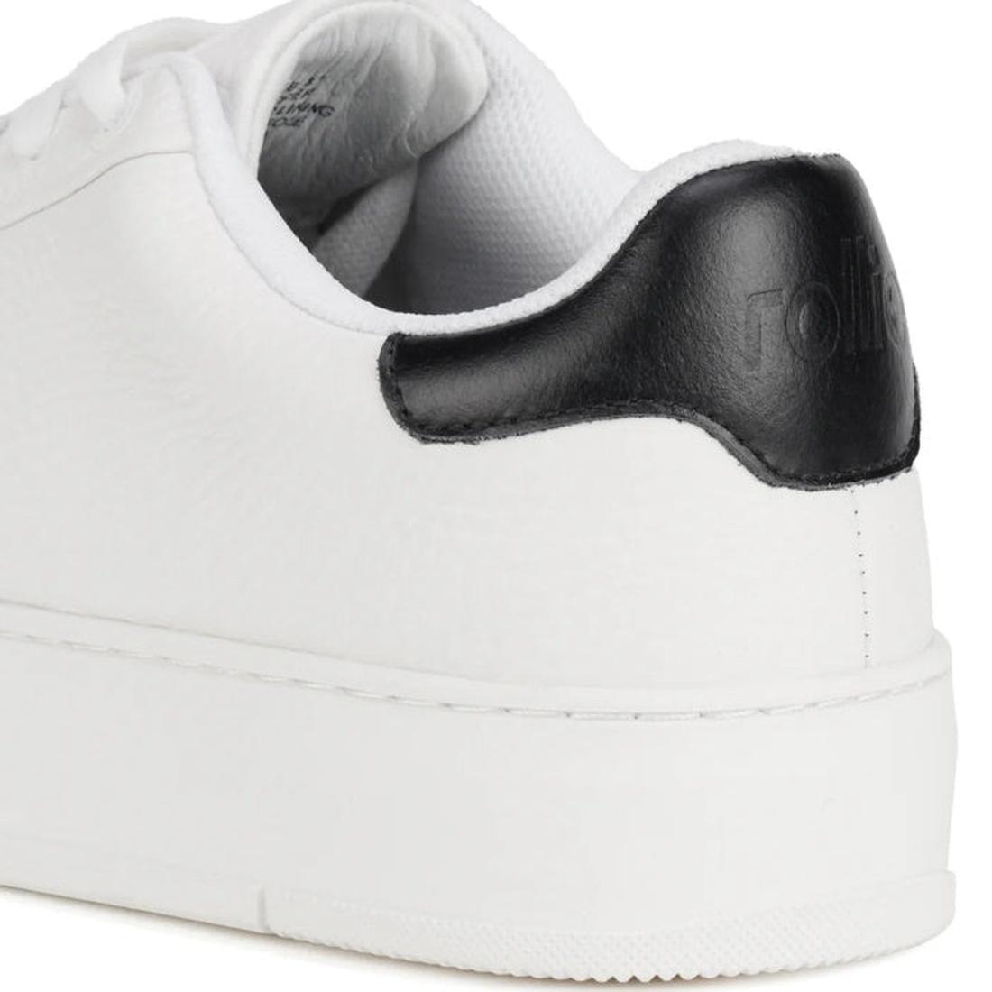Close-up of the Rollies Womens Courtclub All White Black Leather Trainer, highlighting the textured white premium leather, thick sole, black heel tab, visible stitching, and anti-slip rubber outsole for added grip., 9781760790097, 9781760790103, 978176079