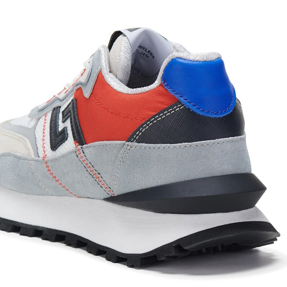 A close-up of the Rollie Womens Kentu Royale Sneaker White Grey shows light gray suede, red and blue accents, a black zigzag logo, and a chunky white/black sole with an anti-slip rubber outsole for added grip., 9339554343853, 9339554343860, 9339554343877,