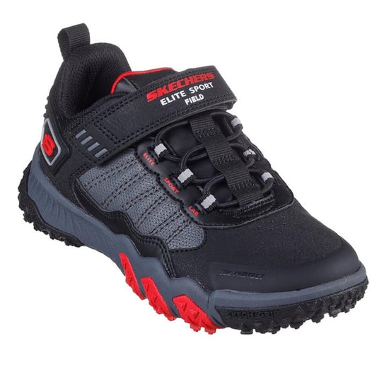 The Skechers Boys Elite Sport Field Black Grey w/ Mini Sprigs sneaker features red accents, a hook-and-loop strap, elastic laces, rugged sole, and cushioned insole for all-day athletic performance.