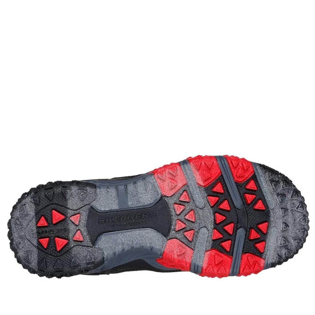 The image shows the sole of the Skechers Boys Elite Sport Field Black Grey w/ Mini Sprigs, featuring black and red rubber lugs for traction. This multi-field athletic shoe offers a rugged, textured design and cushioned comfort insole., 44806, 44807, 19797