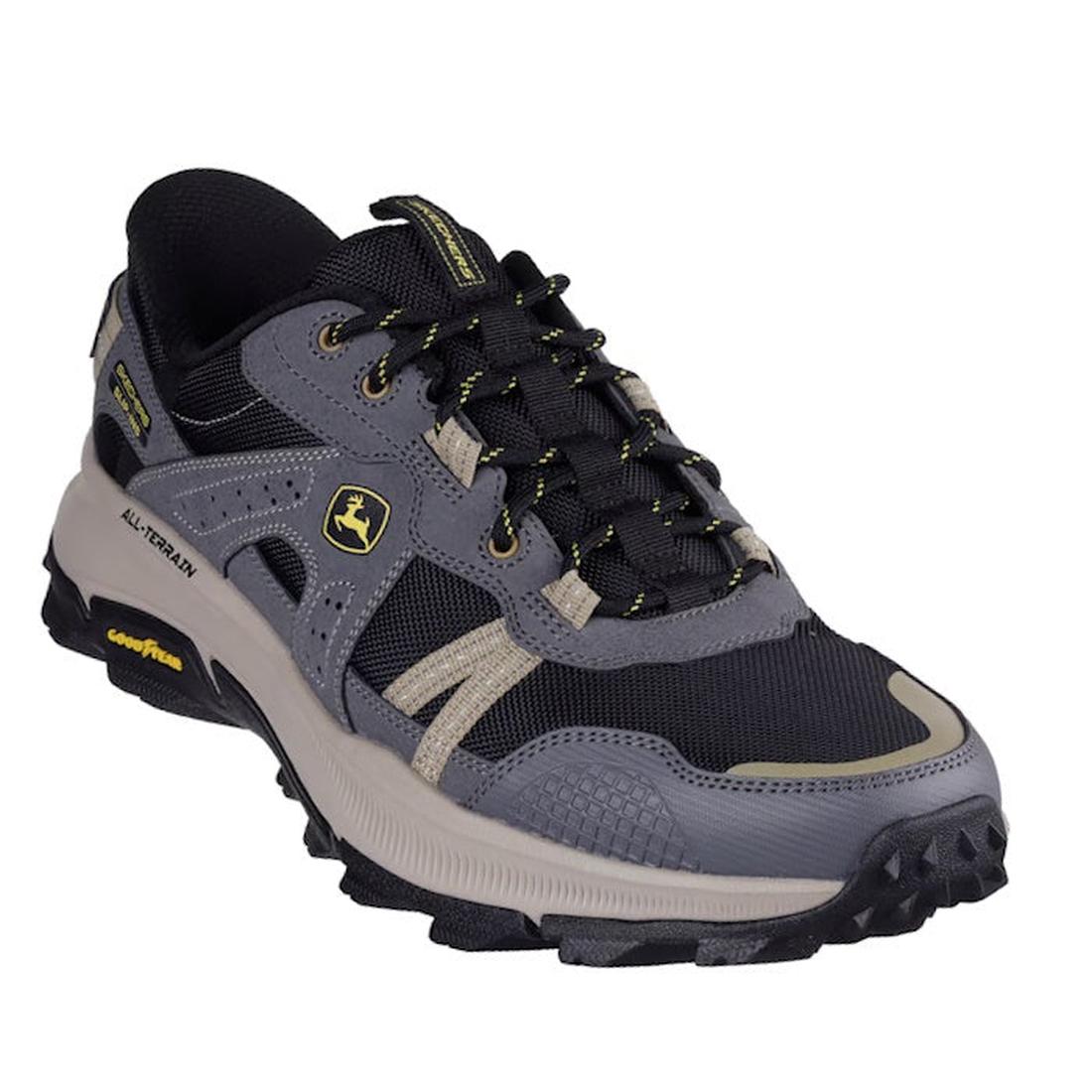 The Skechers John Deere Equalizer 5.0 Trail Harvester Slip Ins in grey, charcoal, and black features a rugged sole, yellow accents, side and tongue branding, mesh/synthetic upper, and Air-Cooled Memory Foam for all-terrain comfort.