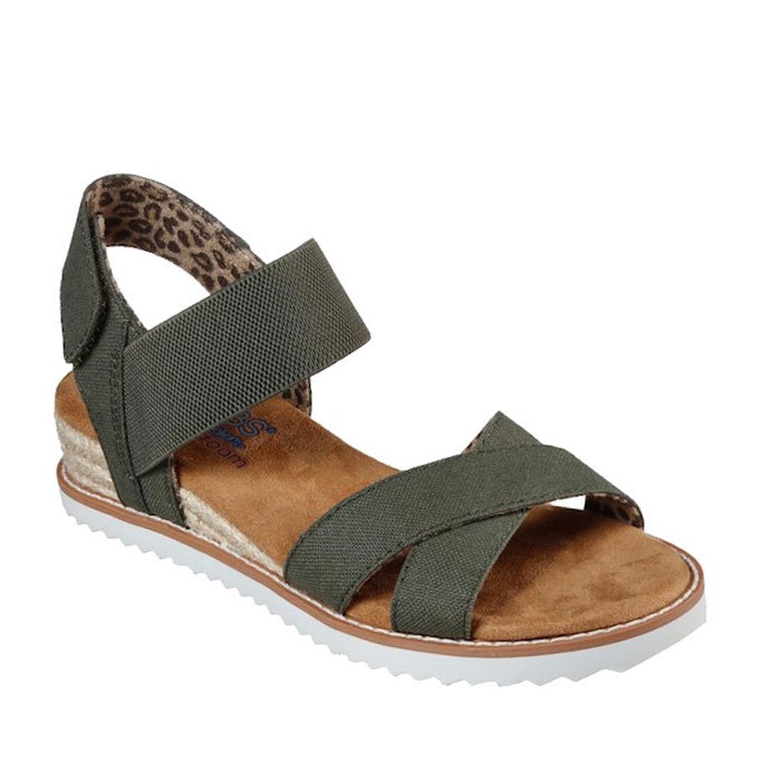 The Skechers Bobs Womens Desert Kiss Secret Picnic Wedge Sandal in olive features green straps, a brown cushioned sole, white ridged outsole, ankle strap, and leopard print lining for a casual, comfortable look with Memory Foam.