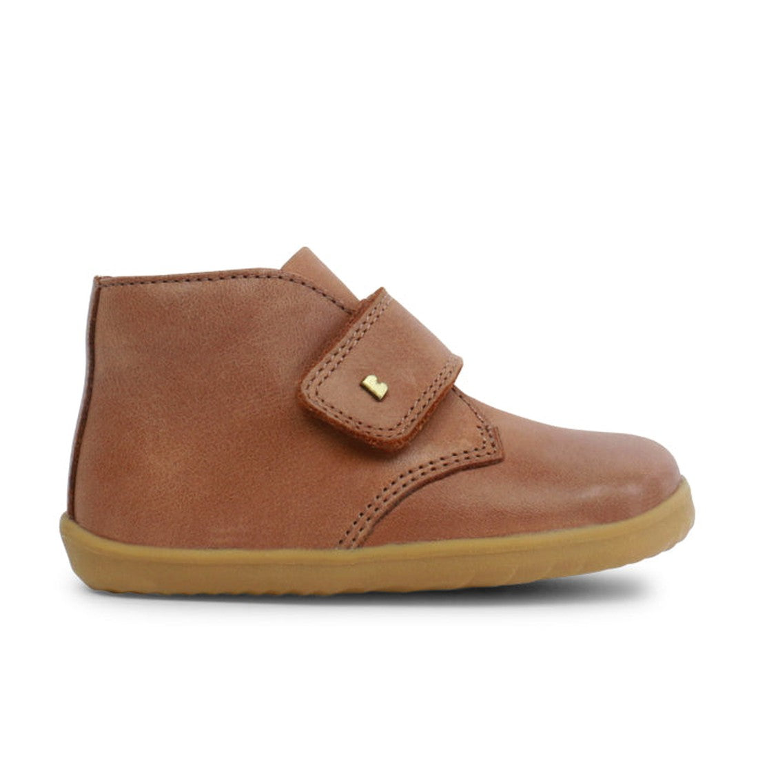 Bobux step up desert boot in caramel tan showing outer foot with thick hoot and loop strap with gold B icon.,9420062056301, 9420062056318, 9420062056325