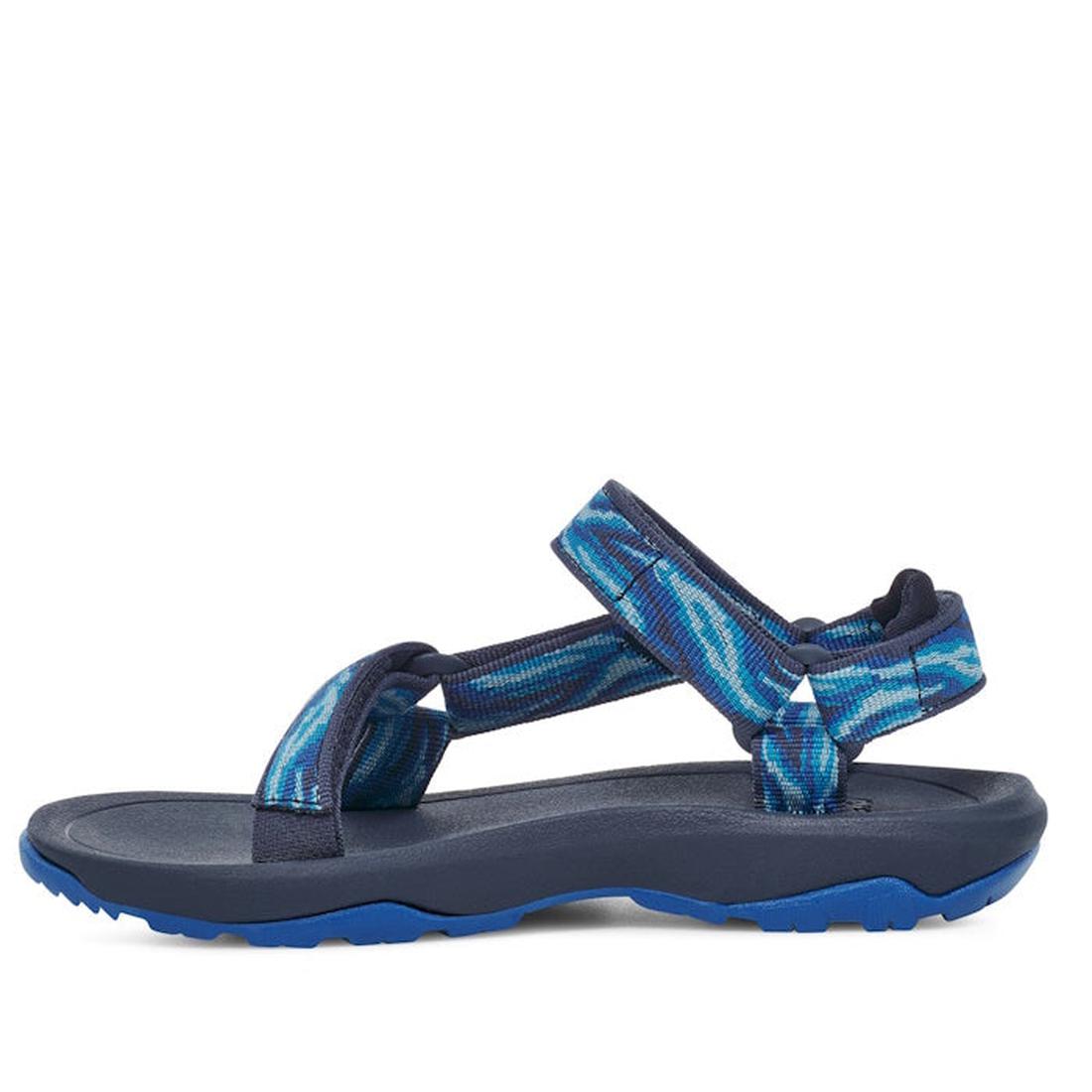 The Teva Kids K Hurricane XLT2 Wave Mood Indigo sandal features adjustable straps, a patterned fabric upper made from recycled plastic webbing, a cushioned footbed, and a textured sole. Shown in side view., 196565099884, 196565099938, 196565099907, 196565