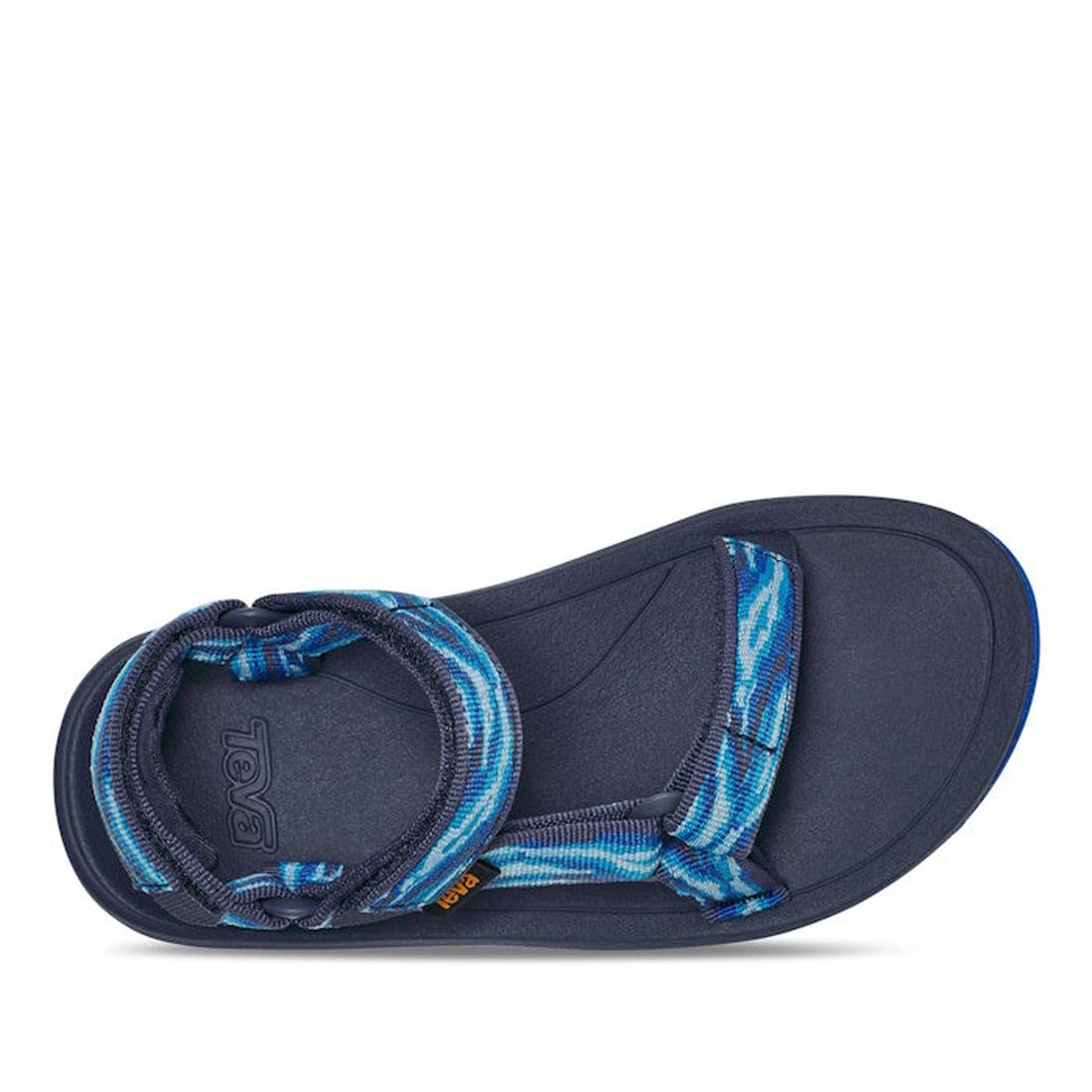 The Teva Kids K Hurricane XLT2 Wave in Mood Indigo is a blue sport sandal with a textured navy footbed, adjustable blue patterned straps made from recycled vegan plastic, Velcro closure, and a contoured sole for comfort., 196565099884, 196565099938, 19656