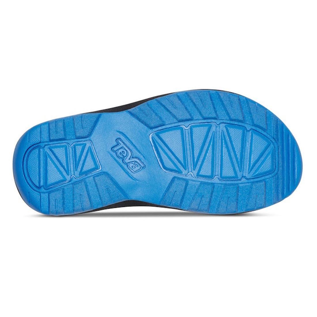 The image shows the blue rubber sole of the Teva Kids - K Hurricane XLT2 Water Multi vegan hiking shoe, featuring geometric tread patterns, textured grooves for traction, and the Teva logo embossed in the center., 196565099600, 196565099655, 196565099624,