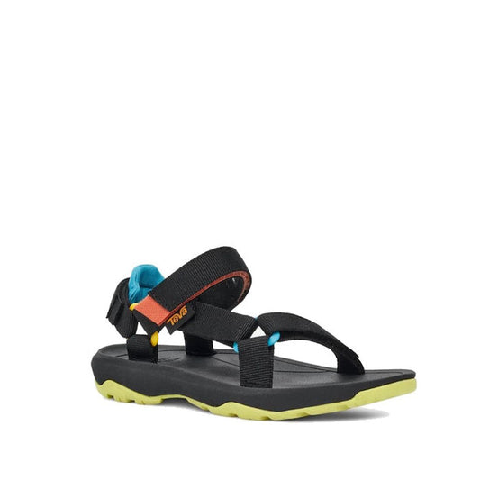 The Teva Kids K Hurricane XLT2 Black Multi is a black hiking sandal with adjustable straps, blue and orange ankle accents, and a yellow-green textured sole—crafted from recycled plastic and shown on a white background.