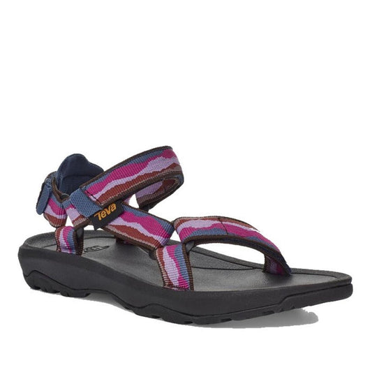A single Teva Kids - K Hurricane XLT2 Girls Active Sandal with a black sole and adjustable straps in purple, pink, and red camo. Features a yellow Teva logo on the side strap and is made with recycled materials—ideal for hiking adventures.