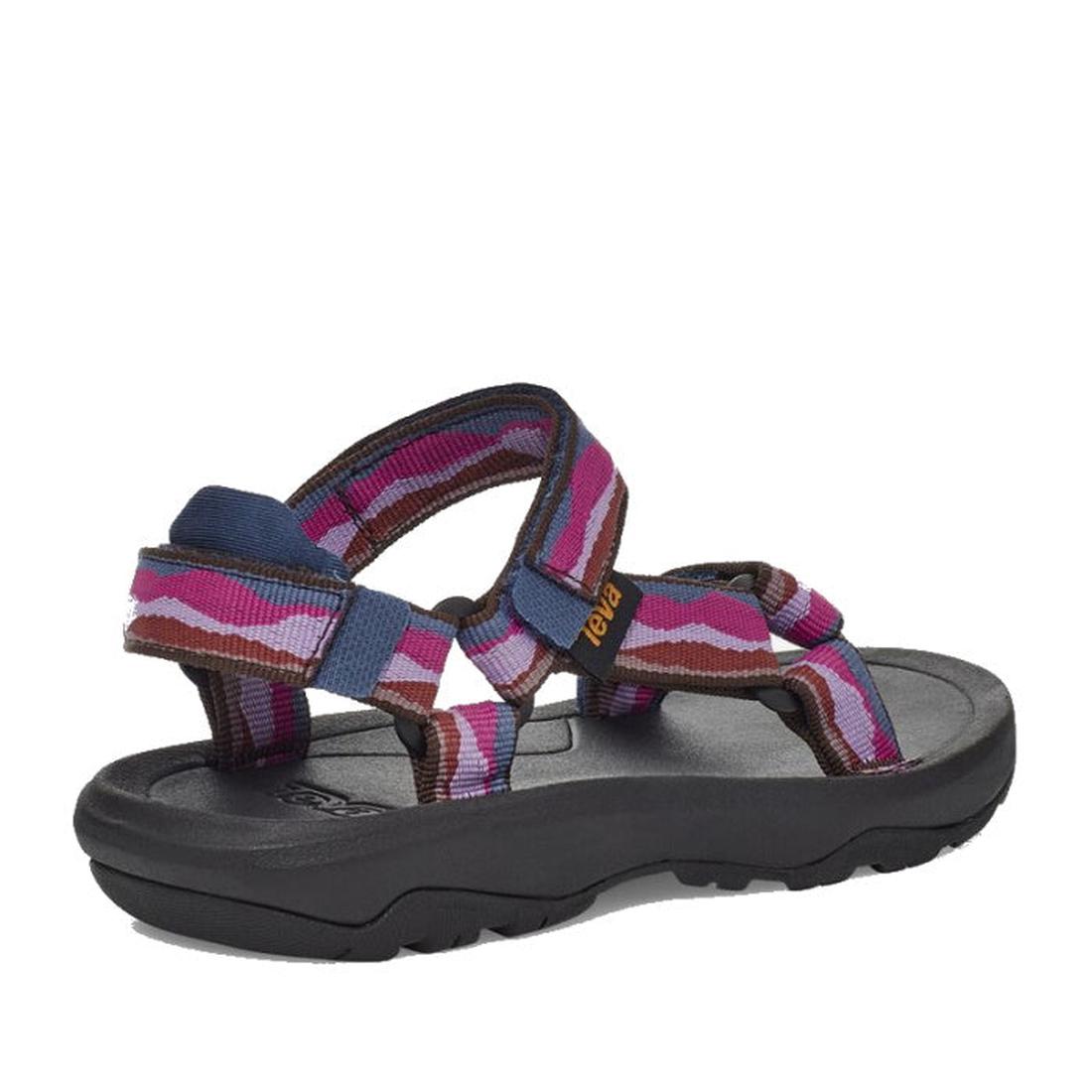 The Teva Kids K Hurricane XLT2 Girls Active Sandal features adjustable blue, pink, and purple recycled fabric straps, a black cushioned sole, and a Teva logo tag. It’s angled on a white background., 194715400955, 194715401006, 194715400979, 194715400924, 