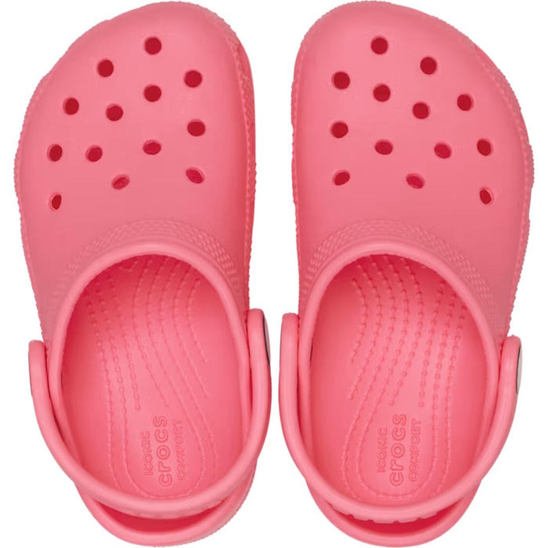 A pair of Crocs Kids Toddlers Classic Clog in Guava Pink, featuring ventilation holes and adjustable heel straps, shown from above., 49822, 49823, 49824, 49825, 49826, 49827, 49822, 49823, 49824, 198445337338, 198445337345, 198445337284