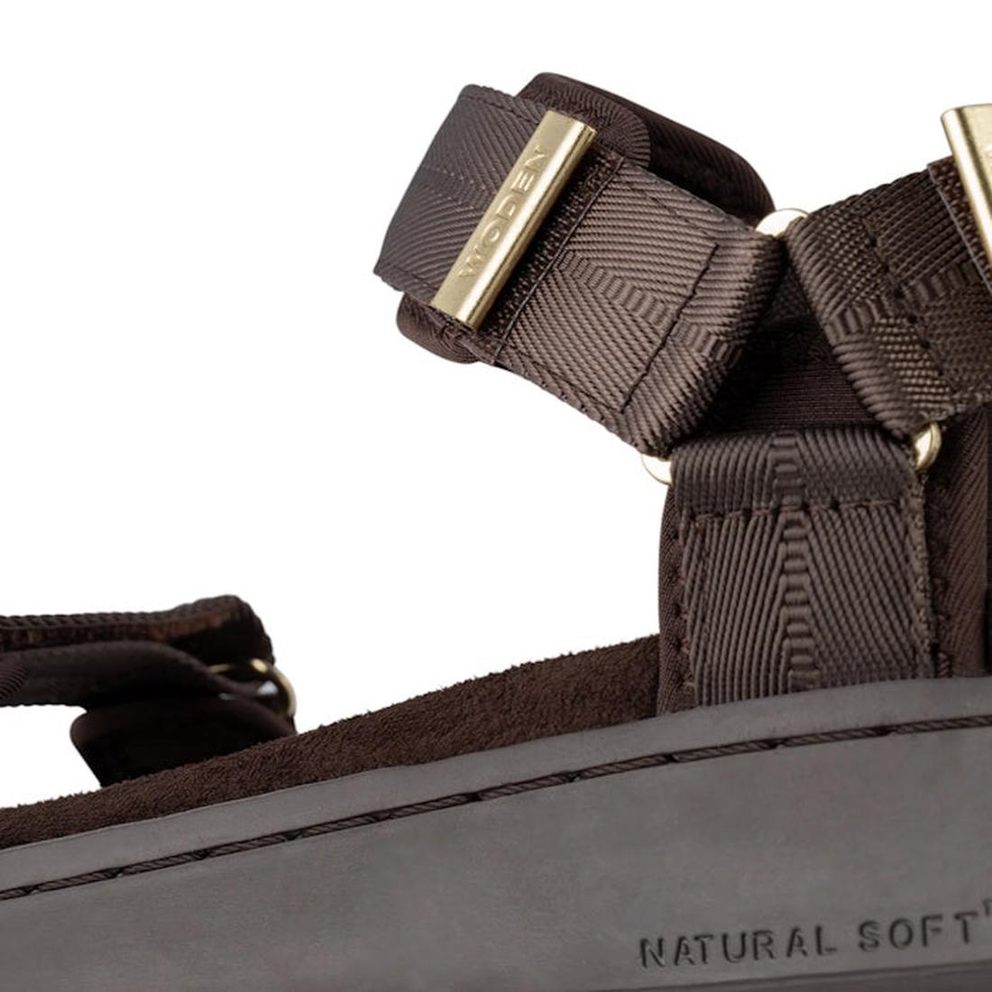 Close-up of the Woden Line Women's 3 Strap Sandal in chocolate brown, featuring adjustable straps with gold-tone hardware and a cushioned sole with visible stitching and NATURAL SOFT embossed on it., 48196, 5713326592511, 5713326592528, 5713326592535, 571